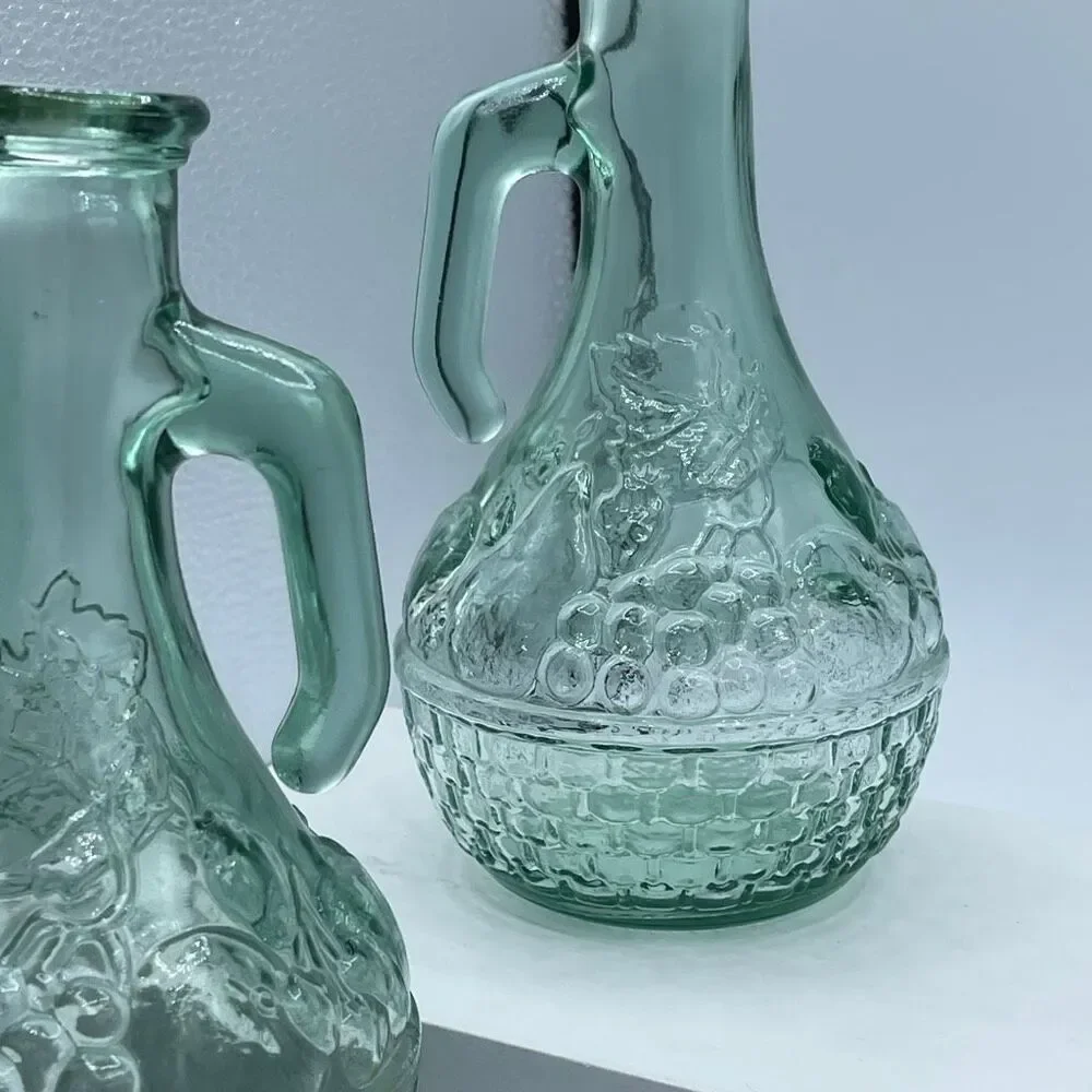 Vintage green cruets decanters embossed basket weave grapes.